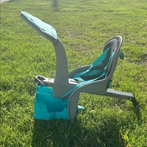 Child Booster Seat with Teal Straps and Gray Frame